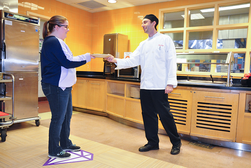 Chef Assisting a student at the Purple Diamon