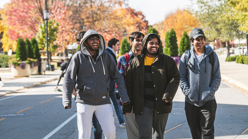 A group of young men walking together and laughing.