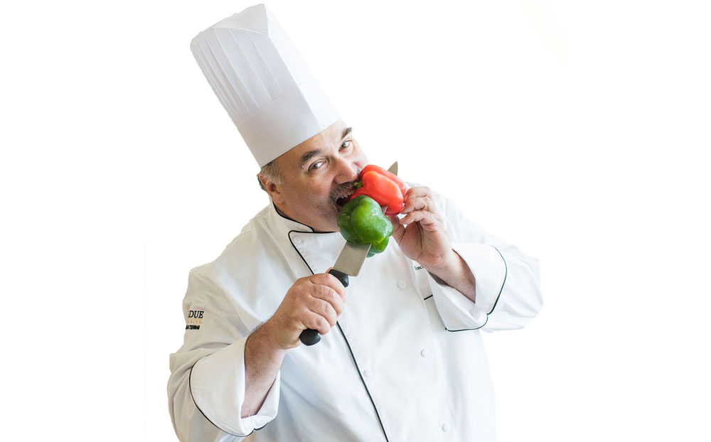 Chef taking a bite out of bell peppers.